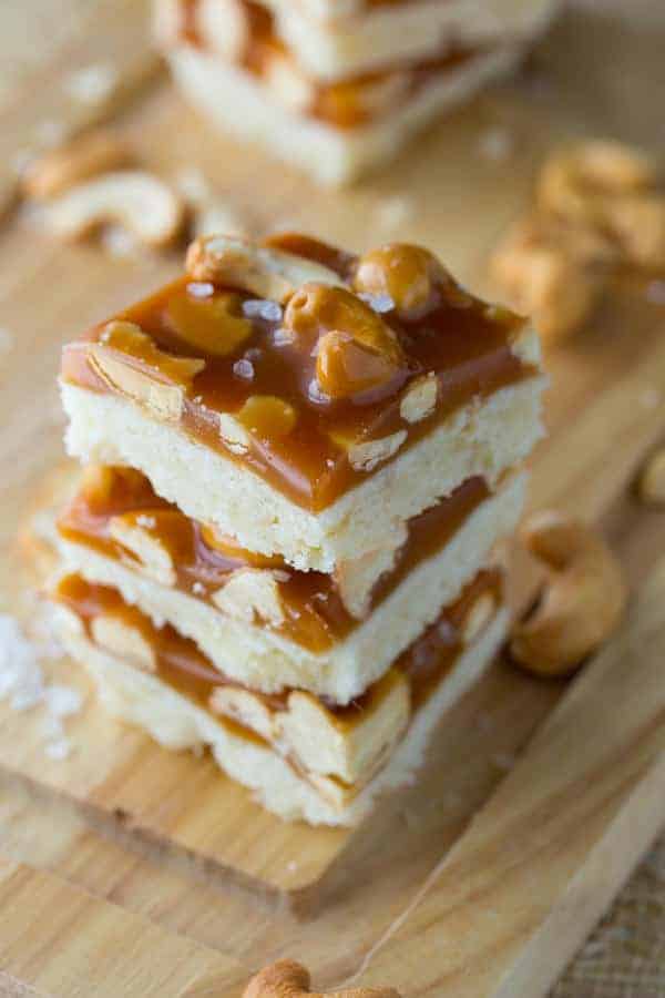 Stack of three Cashew Salted Caramel Bars on cutting board
