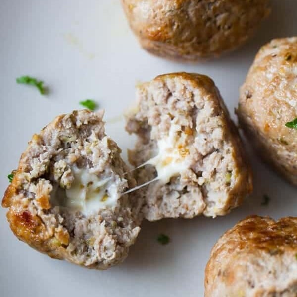 feta stuffed greek turkey meatballs on gray plate with one cut open