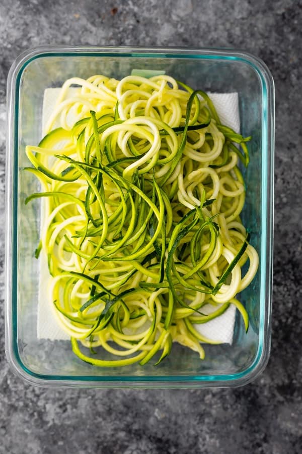 spiralized zucchini in meal prep container from overhead