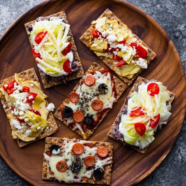 open-faced sandwiches on wooden platter