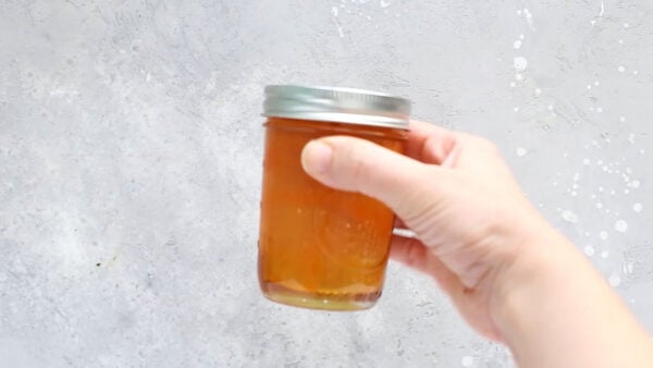 holding a jar of firecracker chicken sauce
